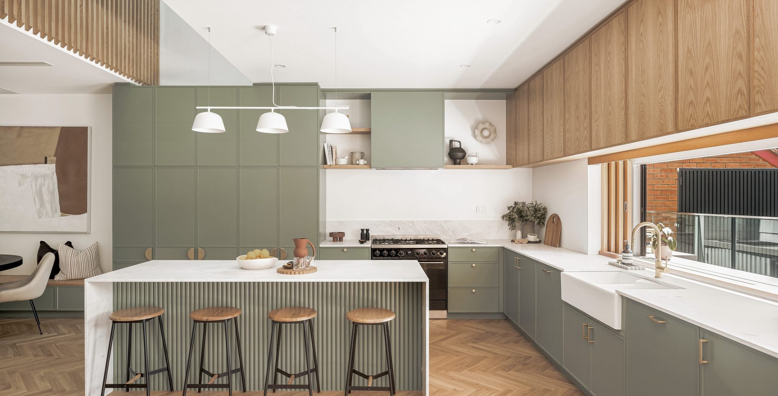 This green kitchen features the Osaka collection in Brushed Brass