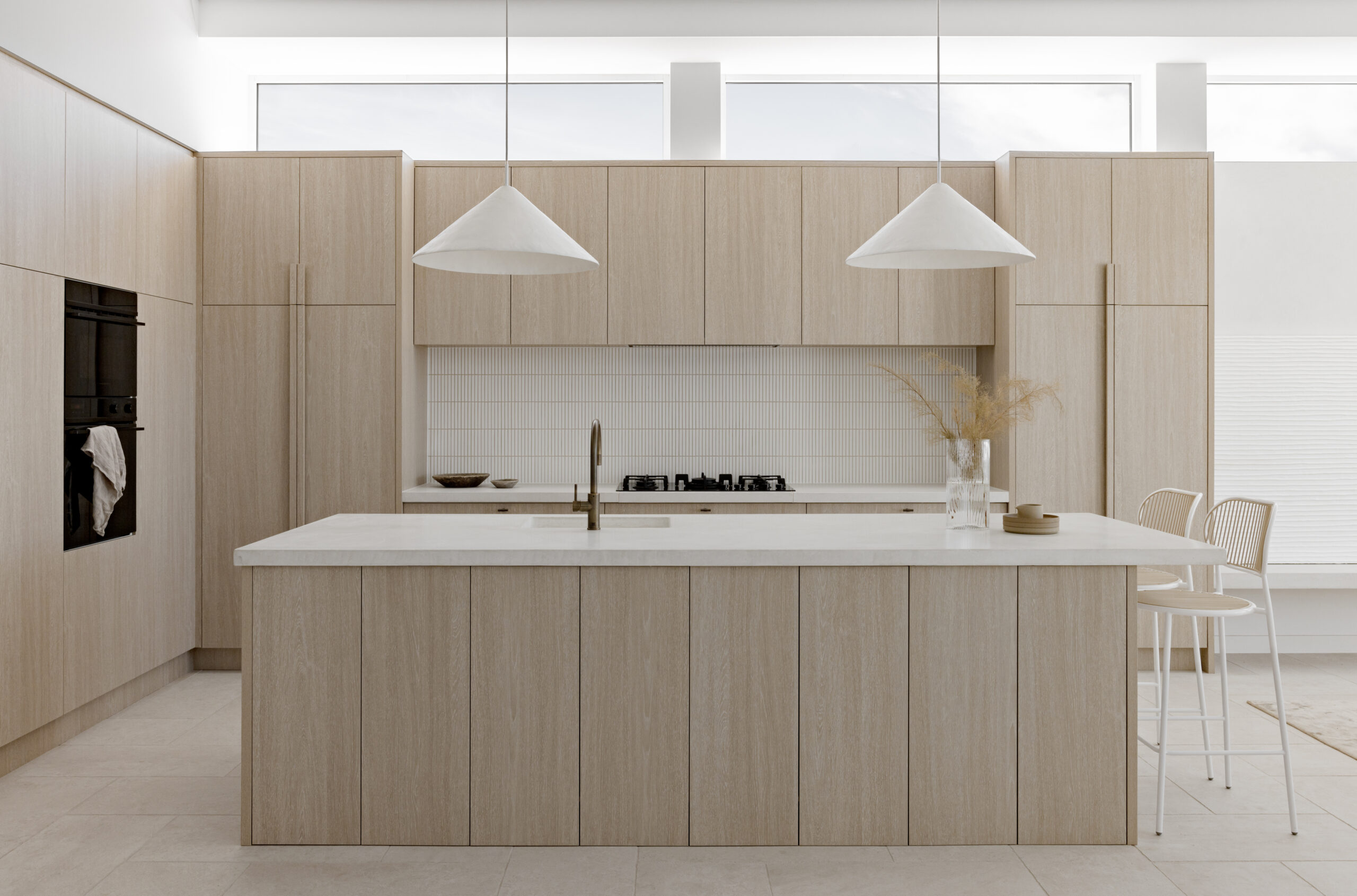 Clisby Way kitchen in light timber and white featuring Iver Brunswick pull handles in matt black.