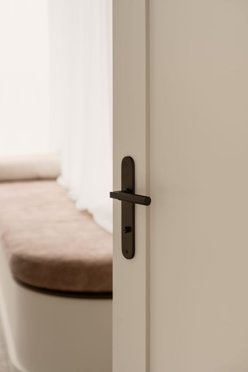 The Berlin Lever on Oval Backplate from Iver hardware adorns this bedroom door.